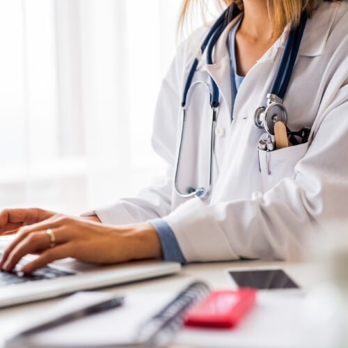 Female doctor with laptop working at the office desk. General practice